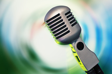 Fototapeta na wymiar Stylish retro microphone on a colored background