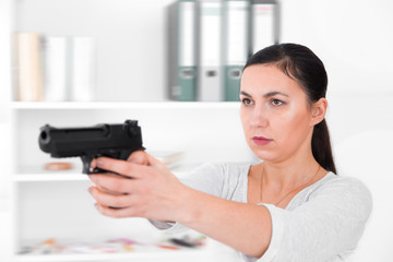 Beautiful woman aiming gun