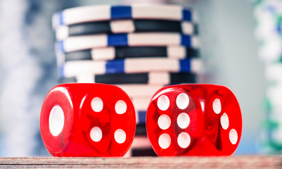 red dice on a casino table with chips