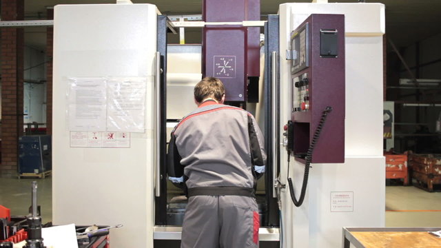 mechanical technician operative of cnc milling cutting machine center 