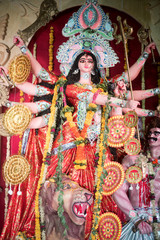 Fototapeta na wymiar MUMBAI, INDIA - October 20, 2015: An idol of revered goddess Durga standing in the temporary temple in the city of Mumbai during Durga Puja festival celebration.