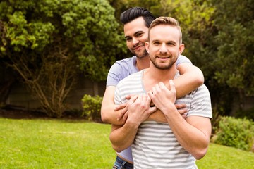 Smiling gay couple hugging 