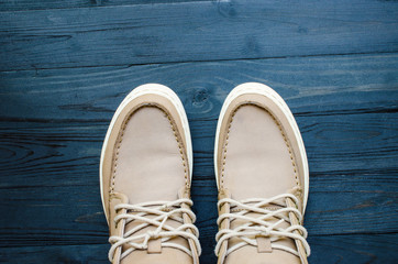 gray Suede Shoes on black wooden background