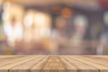 Wooden board empty table in front of blurred background. Perspective brown wood over blur in restaurant - can be used for display or montage your products.Mock up for display of product.