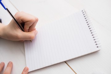 Businesswoman writing on notebook