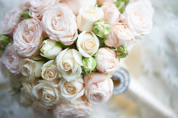 The bride's bouquet from the beautiful cream-colored roses