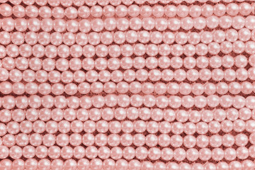 background string of  large pink pearls closeup