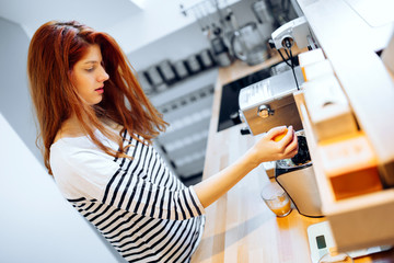 Beautiful woman making organce juice