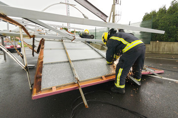 firefighters with electric grinder for remove the  billboard dem