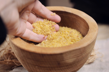 Raw Bulgur on wooden background