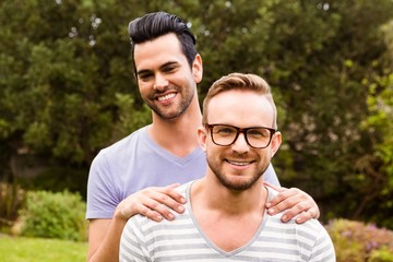 Smiling gay couple hugging 