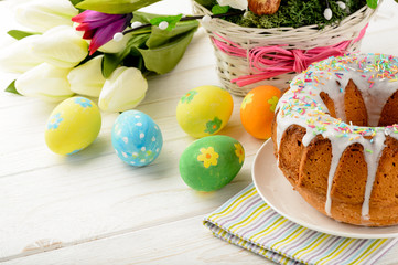 Easter cake and easter decorations on wooden table.