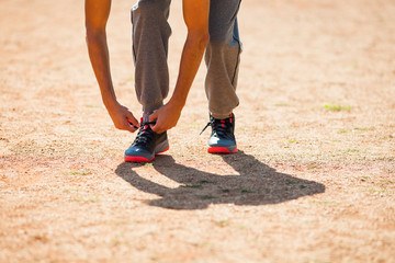 Fototapeta na wymiar Young man tying a shoelace before jogging