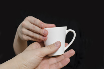white cup of coffee in hands  isolated