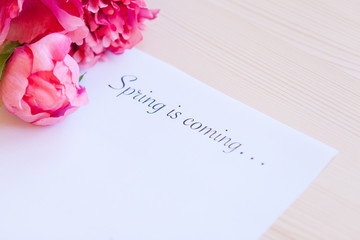 Paper with words Spring in coming