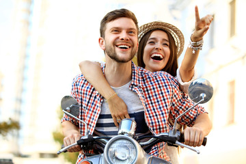 Portrait of happy young couple on scooter enjoying road trip © opolja