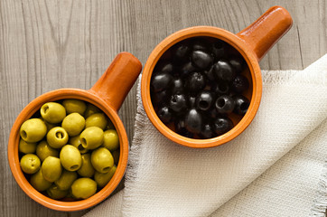 Olives in ceramic cups on the table