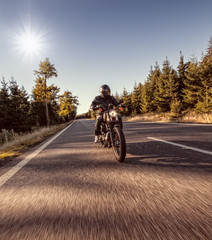 Man seat on the motorcycle on the forest road. © Lukas Gojda