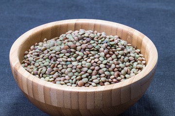 raw colored lentil seed in wooden container