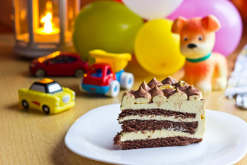Baby boy first birthday party. Focus on cake with blurred multicolored background