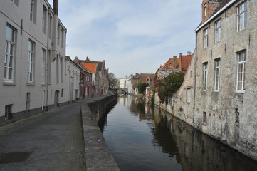 Fototapeta na wymiar View of a typical canal flanked by traditional old buildings in charming Bruges Belgium.