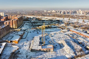 Tyumen, Russia - December 2, 2015: Aerial view on Tychkovka residential district, construction site of residential house, plant on production of prestarting heaters of engine and Tyumen river port