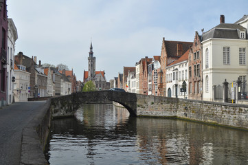 A panorama of picturesque Bruges in Belgium with the Zwin river a bridge and an old distinctive church in the background 