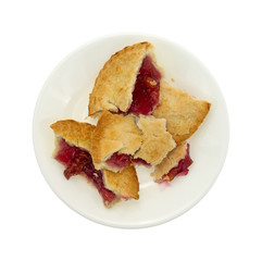 Small cherry pie pieces on a plate isolated on a white background top view