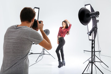 Photographer working with model in studio
