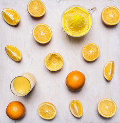 Ingredients for cooking freshly squeezed orange juice fresh oranges and manual juicer on wooden rustic background top view close up