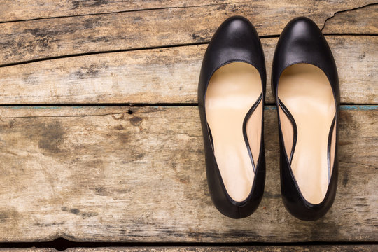 Classic black woman shoes on wooden background