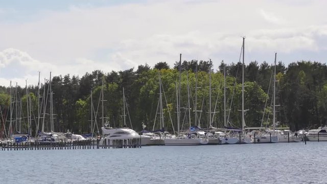 A marina filled with boats (sailboats and motorboats) in Sweden in the summertime.
