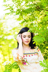 Beautiful  woman standing in a park in spring or summer