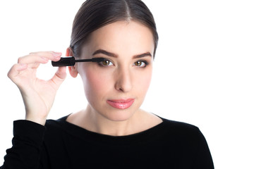 beautiful young woman applied mascara and looking at camera, studio beauty portrait