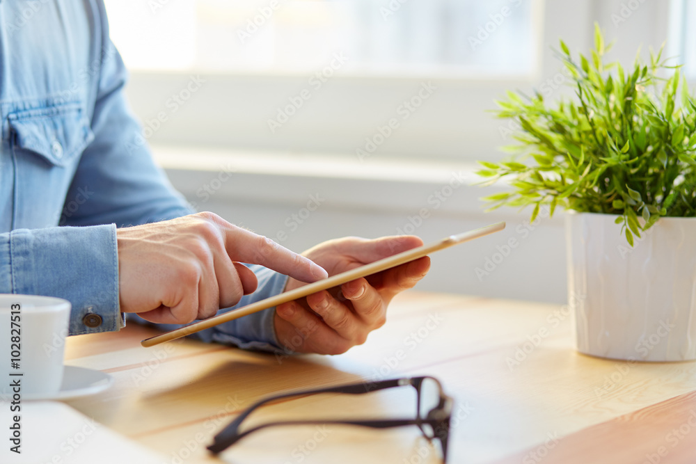 Wall mural man surfs the internet with the tablet
