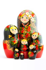 Seven closed traditional Russian matryoshka dolls on white background