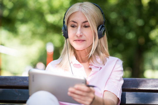 Mature woman listening music