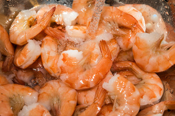 rinsing cooked shrimp in sink with water