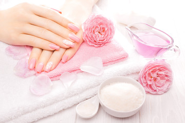 Obraz na płótnie Canvas french manicure with essential oils, rose flowers. spa