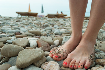 Legs on stone beach
