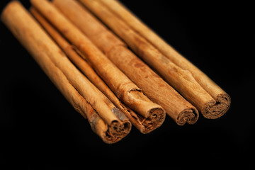 cinnamon sticks isolated on black background