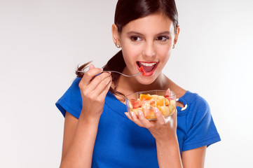 Woman eating a fruit salad