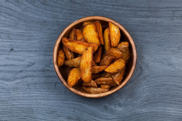 fried potato on wooden background