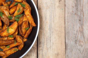 French fries potato on wooden old background. Fast food. Closeup.