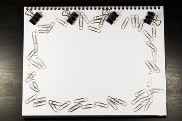 Notebook covered with silver clips and pen, idea concept, business concept.