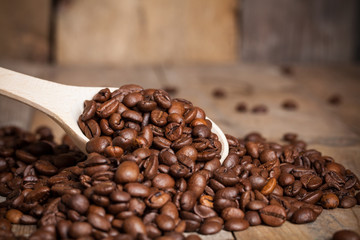 coffee bean on wood scoop on wooden background