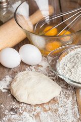 fresh dough ready for baking on rustic wooden background.