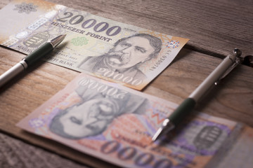 Money and pen on a wooden table - Time is money concept
