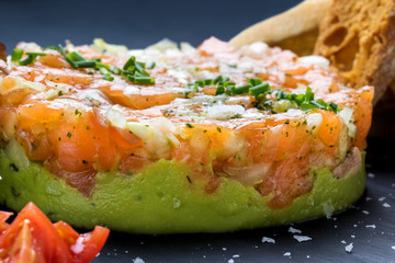 Appetizing smoked salmon tartar with avocado.