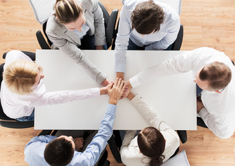 close up of business team with hands on top
